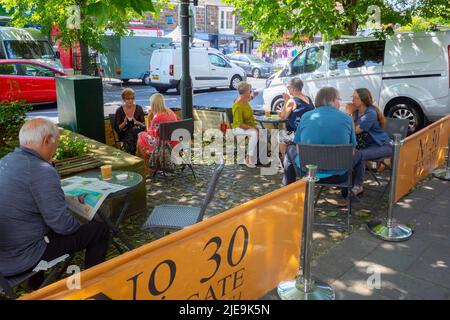 Customers enjoying refreshment outside number 30  Westgate the high street in Guisborough North Yorkshire England Stock Photo