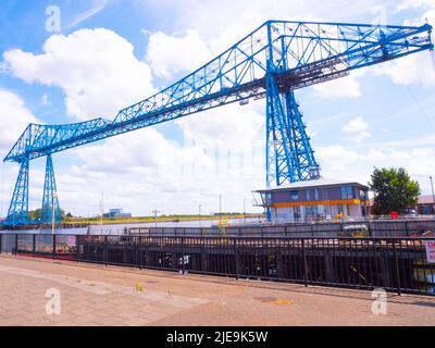 Middlesbrough Transporter bridge from Port Clarence on the north bank of the River Tees with the adjacent Harbour Masters Office Stock Photo