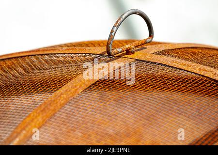 Closeup of a rusty grill top with heavy mesh outdoors Stock Photo