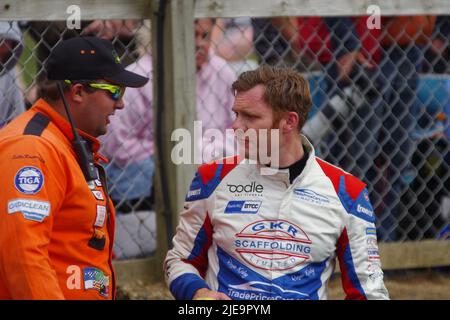 Croft, England, 26 Jun 2022. James Garnall talking to a marshal after crashing a Hyundai during the second race in the Kwik Fit British Touring Car Championship. Credit: Colin Edwards/Alamy Live News Stock Photo