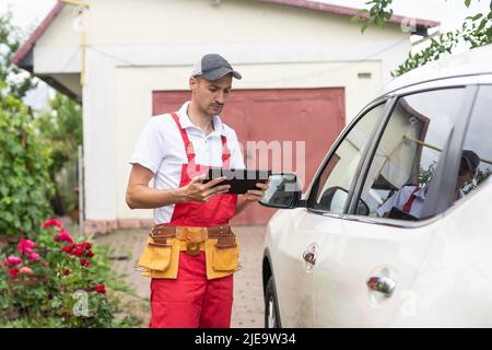 mechanic using digital tablet in workshop Stock Photo