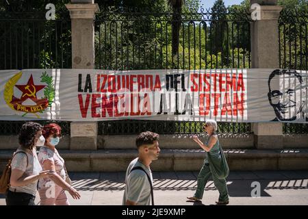 Madrid, Spain. 26th June, 2022. A communist banner is seen displayed at Paseo del Prado in Madrid. Protest groups against NATO (North Atlantic Treaty Organization) and against war took to the streets of Madrid in a demonstration. This year Madrid is the venue for the NATO summit. Multiple groups from all over Spain and Europe traveled to participate in the demonstration. Credit: SOPA Images Limited/Alamy Live News Stock Photo