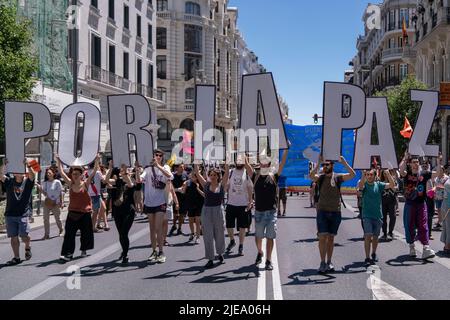 Madrid, Spain. 26th June, 2022. Protesters hold For Peace letters during the demonstration. Hundred of people took part in a demonstration against NATO summit that will take place in Madrid next week. (Photo by Guillermo Gutierrez/SOPA Image/Sipa USA) Credit: Sipa USA/Alamy Live News Stock Photo