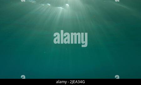 Red Sea, Egypt. 26th June, 2022. Sunrays penetrate through the surface of the water. Underwater light creates a beautiful veil, consisting of sunlight. range rays of the sun at sunset under the surface of the water. Red sea, Egypt (Credit Image: © Andrey Nekrasov/ZUMA Press Wire) Stock Photo