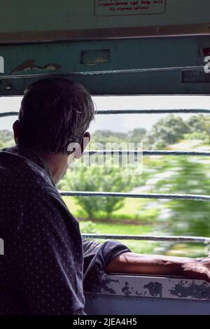 A man looking outside through a train window. Concept - traveling. Stock Photo