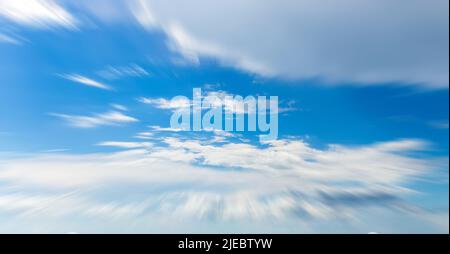 Panorama of blue sky with white clouds in clear weather with motion blur effect Stock Photo