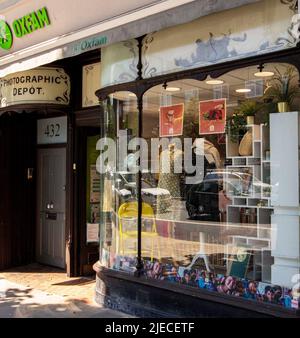 The King's Road, London, UK; a fashionable shopping street showing the Oxfam shop which features in The Amazing Story of Us Stock Photo