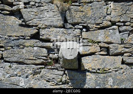 Human face carved into the stonework of O'Briens Castle on Inis Oirr in Ireland Stock Photo