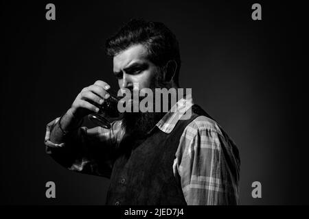 Man Bartender holding glass of whisky. Degustation and tasting. Stock Photo