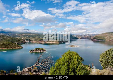 Flaming Gorge lake overlook from up high with partly cloudy skies and smooth water on the lake. Stock Photo