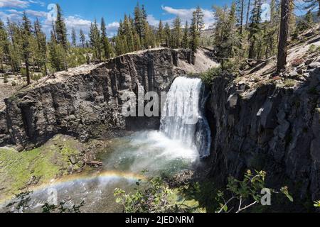 View of Rainbow Falls with rainbow near Devils Postpile and Mammoth Lakes in the California Sierra Nevada Mountains. Stock Photo