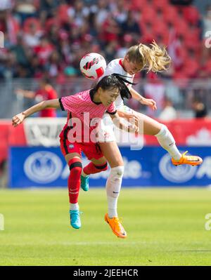 Toronto, Canada. 26th June, 2022. Janine Beckie (R) of Canada vies with Jang Selji of South Korea during a football friendly match between Canada and South Korea at BMO Field in Toronto, Canada, on June 26, 2022. Credit: Zou Zheng/Xinhua/Alamy Live News Stock Photo