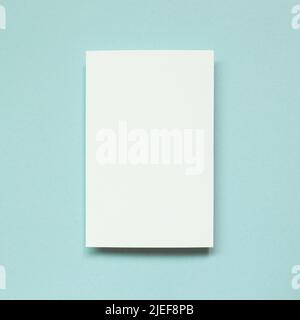 Blank white memo paper on blue background. top view, copy space Stock Photo