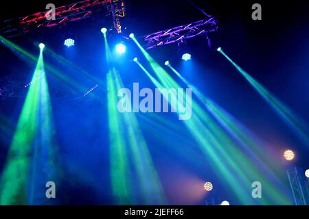 Crowd at concert - Cheering crowd in bright colorful stage lights Stock Photo