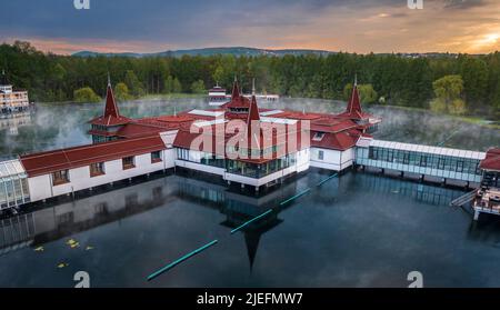 Heviz, Hungary - Aerial view of Lake Heviz at sunrise, the world’s second-largest thermal lake and holiday spa destination at Zala county on a summer Stock Photo
