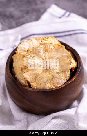 Dried pineapple slices. Sliced dried pineapple on dark background. Sun-dried fruit. close up Stock Photo