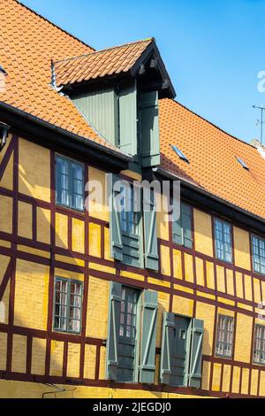 Traditional half-timbered warehouses and old yellow houses in the historic city center of Odense. Odense, Fyn, Denmark, Europe Stock Photo