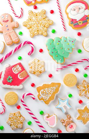 Christmas sweets set. Assorted festive Christmas and New Year sweets, traditional candy and cookie. Flatlay with candy cane candies, gingerbread, swee Stock Photo