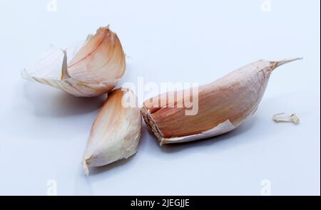 three cloves of garlic on light background Stock Photo