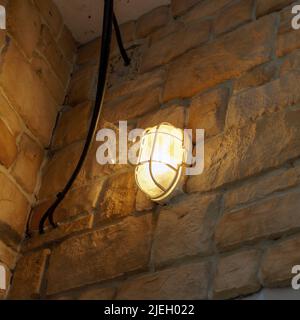Electric lantern on a brick or stone wall Stock Photo
