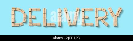 Word DELIVERY from cardboard boxes on blue background. Stock Photo