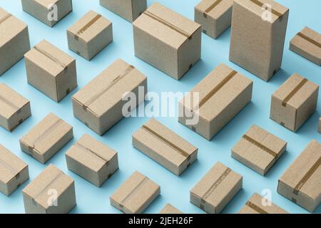Lots of cardboard boxes pattern on a blue background. Stock Photo