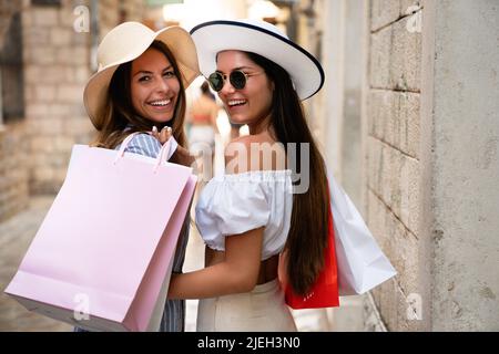 Sale and tourism, happy people concept. Beautiful women with shopping bag in the ctiy Stock Photo