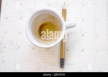 empty cup of coffee on a work diary Stock Photo