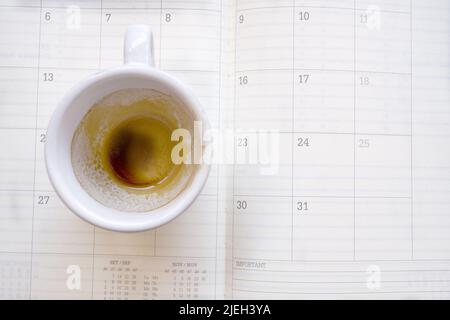 empty cup of coffee on a work diary Stock Photo