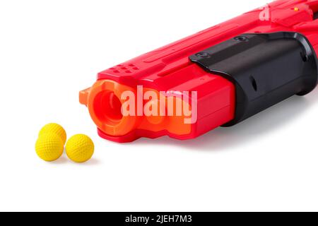 Barrel of children's plastic toy gun with rubber balls for shooting isolated on white Stock Photo