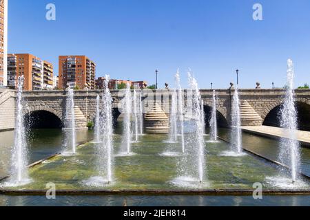 Madrid Rio Park. Views of the Madrid Río park next to the Manzanares river and green vegetation around it. Roads with bridges and footbridges. Stock Photo