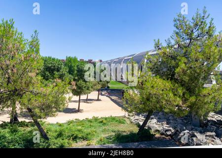 Madrid Rio Park. Views of the Madrid Río park next to the Manzanares river and green vegetation around it. Roads with bridges and footbridges. Stock Photo