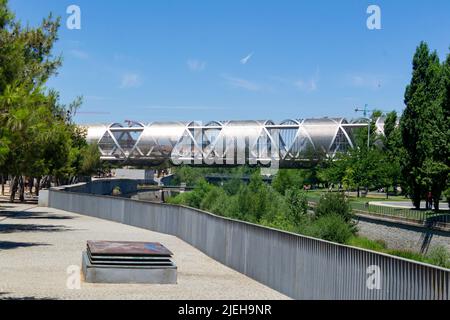 Madrid Rio Park. Views of the Madrid Río park next to the Manzanares river and green vegetation around it. Roads with bridges and footbridges. Stock Photo