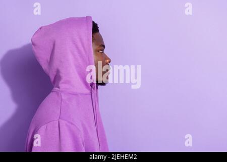 Profile side view portrait of attractive guy wearing cozy clothes copy space isolated over bright violet lilac color background Stock Photo