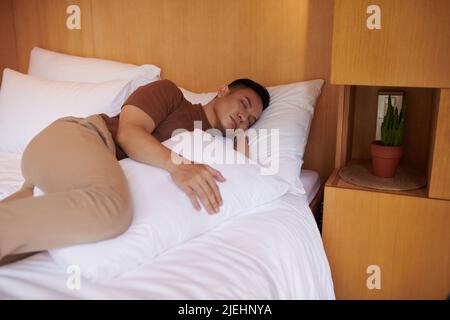 Sleeping with pillow between legs hi-res stock photography and images -  Alamy