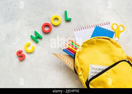 School backpack with school items and students equipment, top view Stock Photo