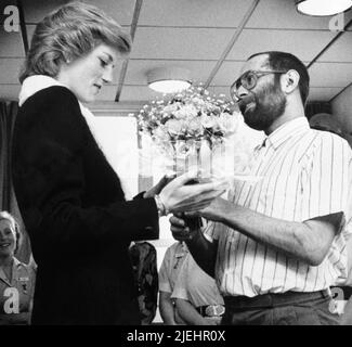 PA News photo dated February 1989. Pictured: The Princess of Wales is presented with a bouquet by Aids patient Martin Johnson during her visit to the Mildmay Mission Hospital Aids Hospice in East London. PA Feature SHOWBIZ Film Reviews. Picture credit should read: PA Archive/PA Images. All Rights Reserved. WARNING: This picture must only be used to accompany PA Feature SHOWBIZ Film Reviews. Stock Photo