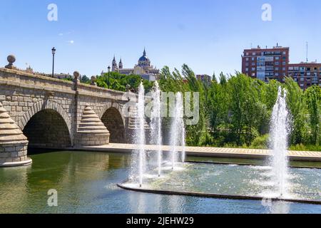 Madrid Rio Park. Views of the Madrid Río park next to the Manzanares river and green vegetation around it. Roads with bridges and footbridges. Stock Photo