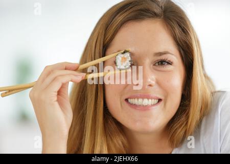 happy young fun woman with sushi on white background Stock Photo