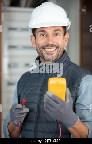 portrait of a young electrician using a multimeter Stock Photo