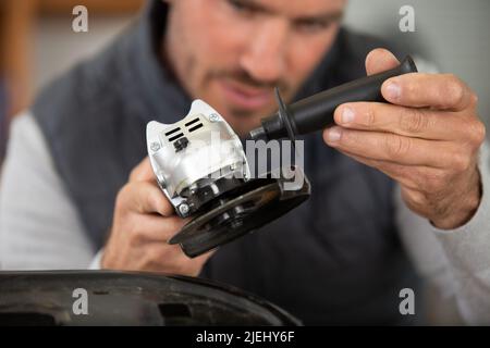 construction worker using handheld circular saw Stock Photo
