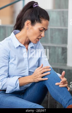 woman has fallen and hurt her leg Stock Photo