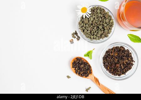 Varieties of premium black or red and green tea , Chinese oolong tea with ginseng, brewed tea in cup. Assortment of tea in shop. White background. Top Stock Photo