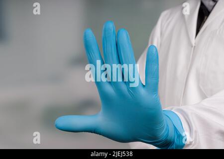 Close up of hands in medical gloves show stop Stock Photo