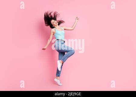 Full size profile photo of cool millennial lady dance wear blue top jeans isolated on pink color background Stock Photo