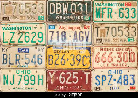 Drempt, The Netherlands - June 16, 2022: Retro styled image of old car license plates on a wall in Drempt, The Netherlands. Stock Photo