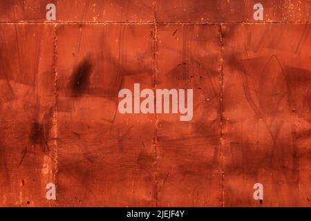 Metallic surface painted in brown color with stains and scratch marks as background Stock Photo
