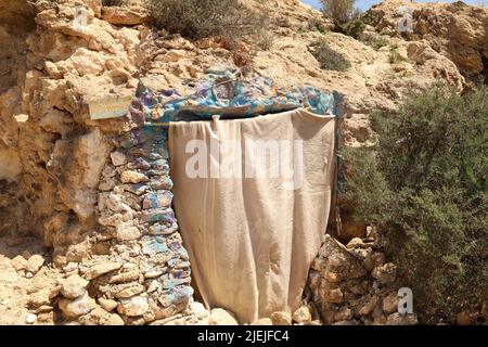 Blanket closing the entrance of a natural cave on the hill of Almeria Spain Stock Photo