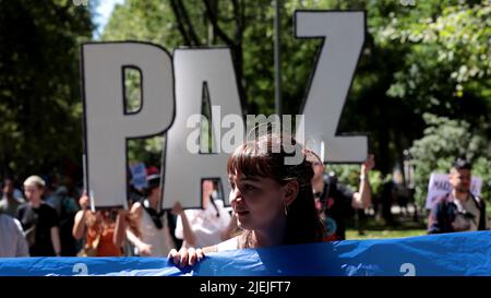 Elmau, Spain. 26th June, 2022. A woman takes part in a protest against NATO in Madrid, Spain, June 26, 2022. Credit: Juan Carlos Rojas/Xinhua/Alamy Live News Stock Photo
