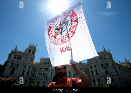 Elmau, Spain. 26th June, 2022. A man takes part in a protest against NATO in Madrid, Spain, June 26, 2022. Credit: Juan Carlos Rojas/Xinhua/Alamy Live News Stock Photo